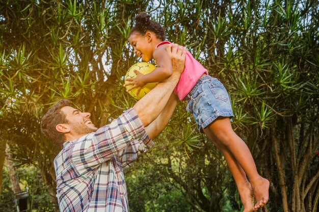 Father lifting daughter