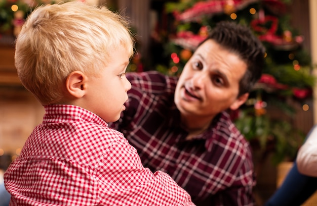 Free photo father looking at his son serious