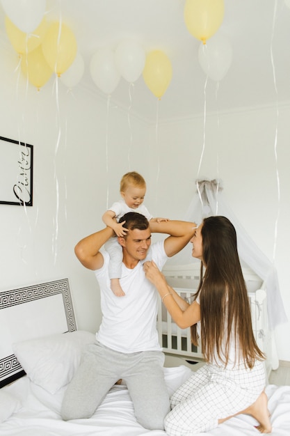 Father, mother and their little son have fun at one in the morning