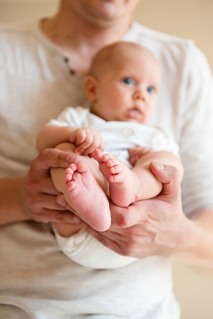 Father and newborn close up