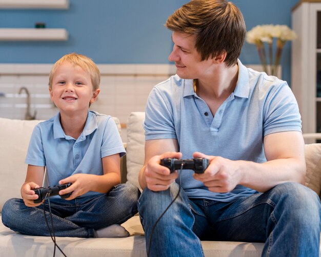 Father playing video games together with son