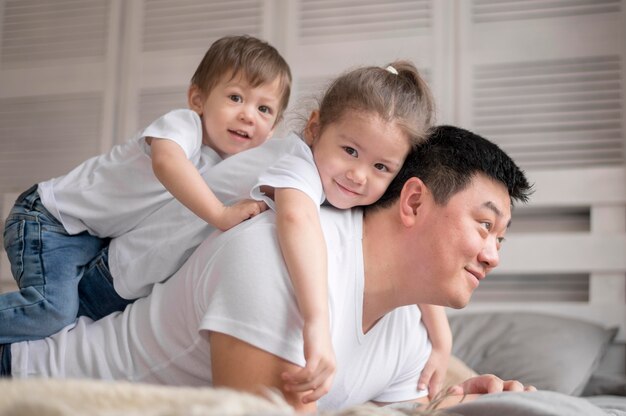 Free photo father playing with daughter and son