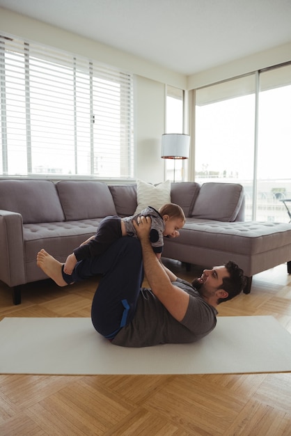 Father playing with his baby in living room