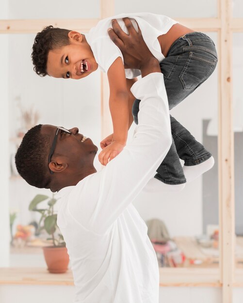 Father playing with his son indoors