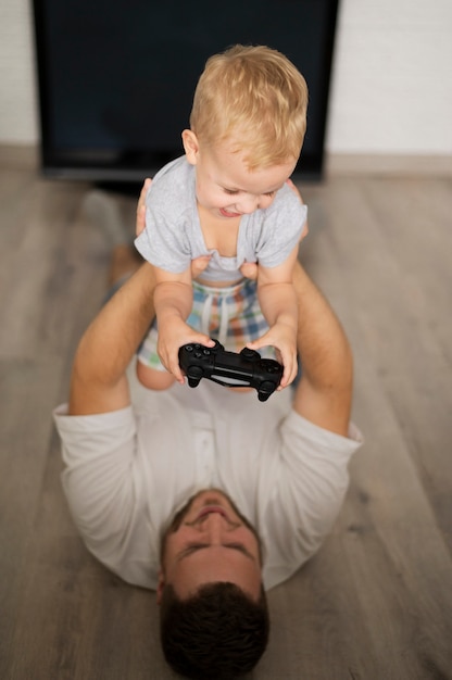 Father playing with son at home