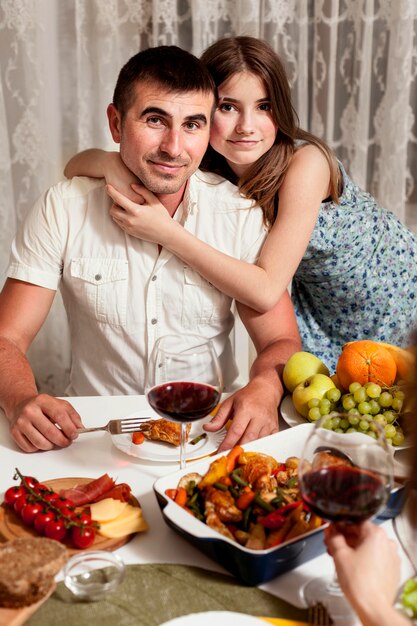Father posing with daughter at dinner table
