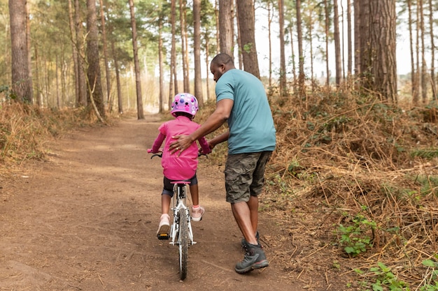 Father preparing his kid for a bicycle ride