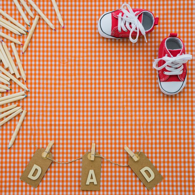 Father's day background with shoes and colored pencils