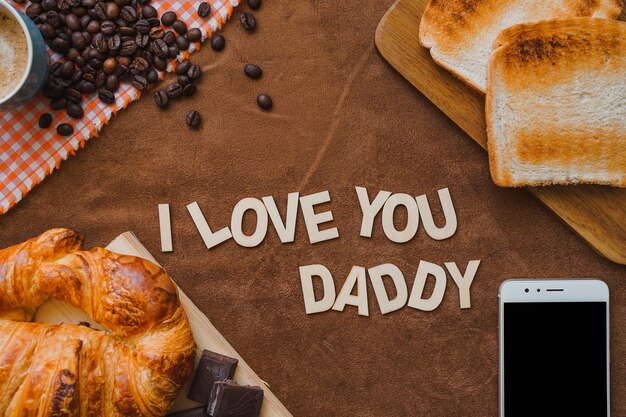 Father's day composition with breakfast, mobile phone and coffee beans
