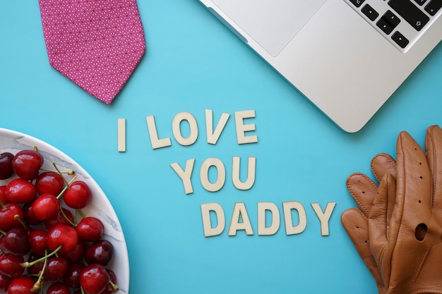 Father's day composition with cherries and teddy bear