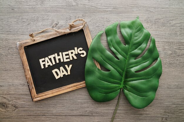 father's day composition with slate and palm leaf
