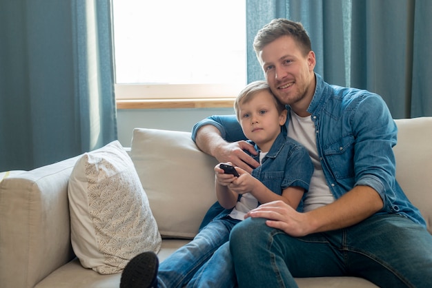 Father's day dad and son holding a remote