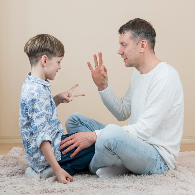 Father's day dad and son playing rock paper scissors