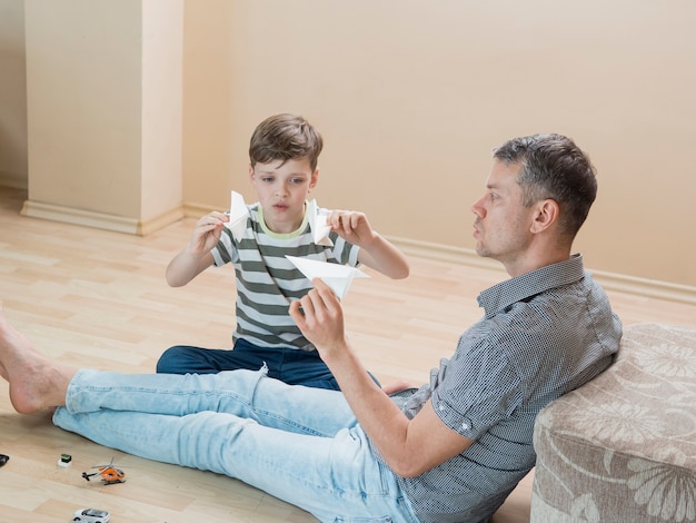 Festa del papà papà e figlio che giocano con gli aerei di carta