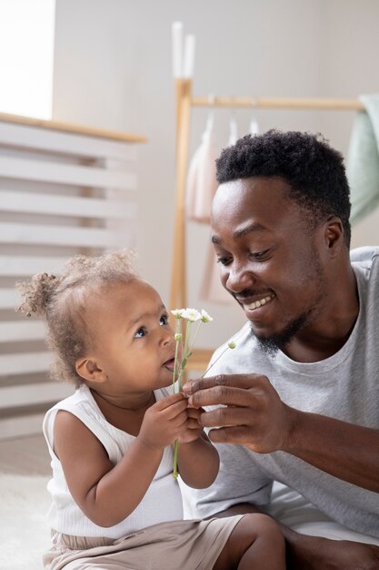 Father showing some flowers to his little girl