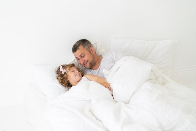 Father sitting with daughter in the bedroom