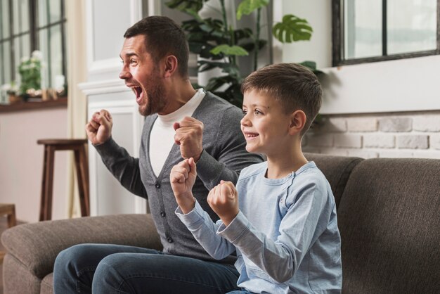 Father and son cheering together