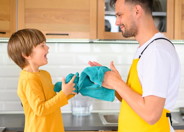 Father and son cleaning their hands with towels