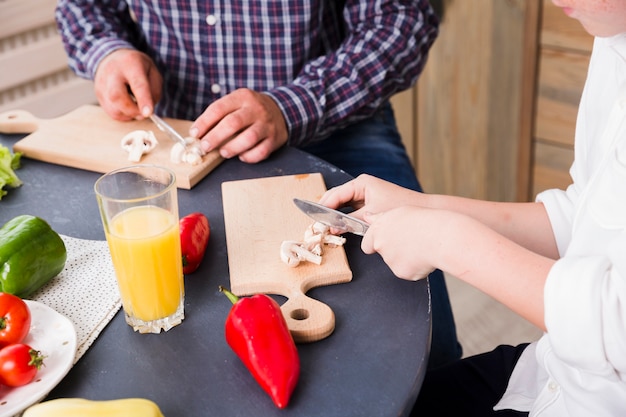 Free photo father and son cooking together