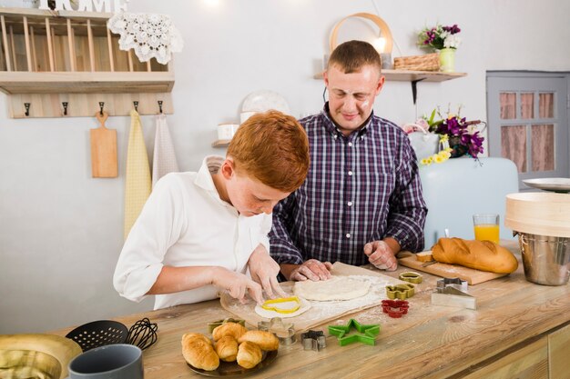 Father and son cooking together