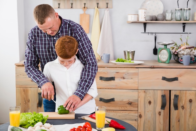 Father and son cooking together