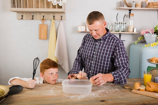 Father and son cooking together