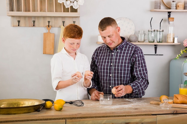 Free photo father and son cooking together