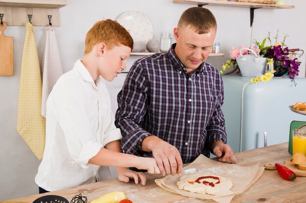 Father and son cooking together