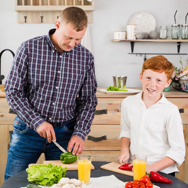 Father and son cooking together