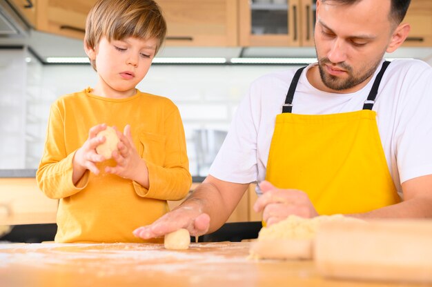 父と息子が生地ミディアムショットのボールを作成