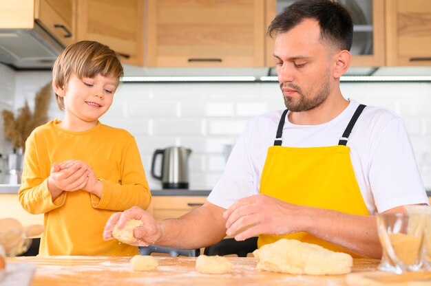 Father and son creating balls of dough