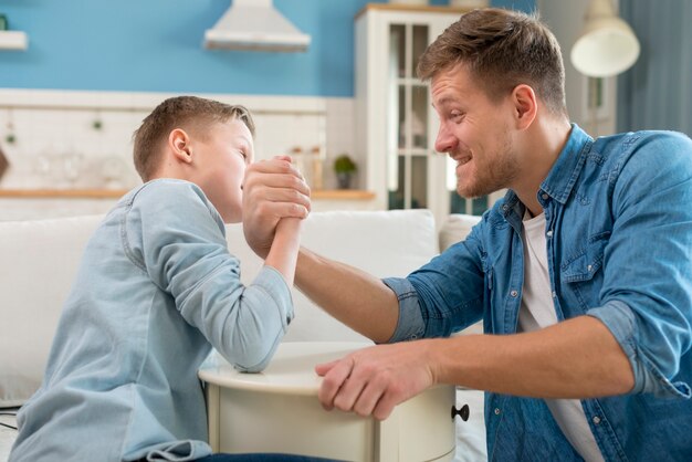 Father and son doing  arm wrestling