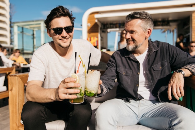 Father and son drinking cocktail