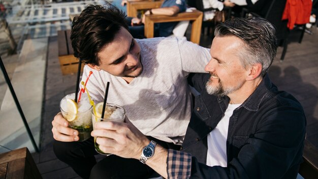 Father and son drinking cocktail