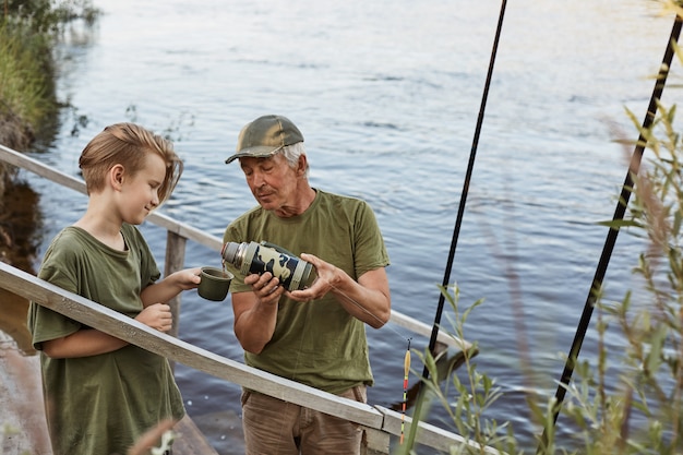 Father and son fishing in the river