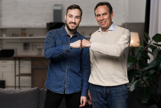 Free photo father and son fist bumping