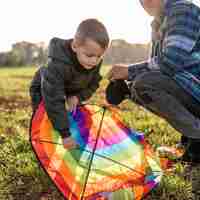 Free photo father and son fixing a kite