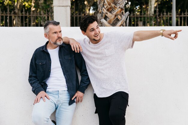 Father and son in front of wall