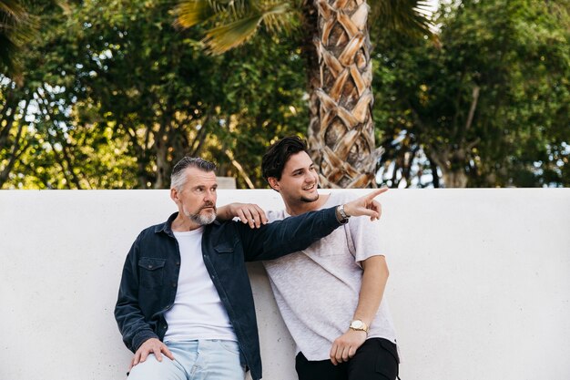 Father and son in front of wall