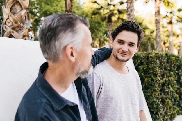 Father and son in front of wall