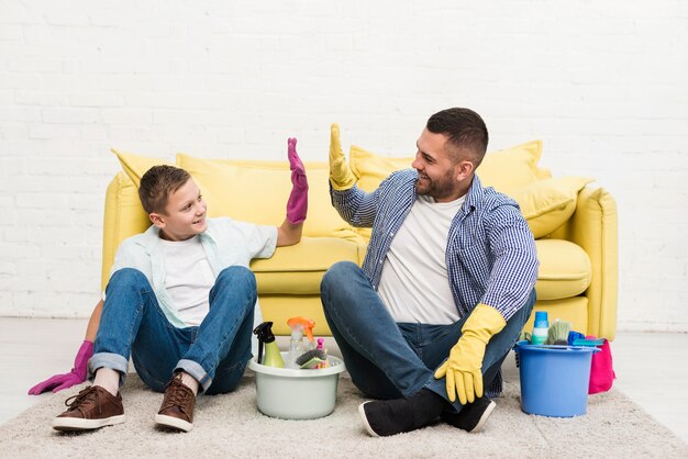 Padre e figlio si divertono a vicenda mentre puliscono