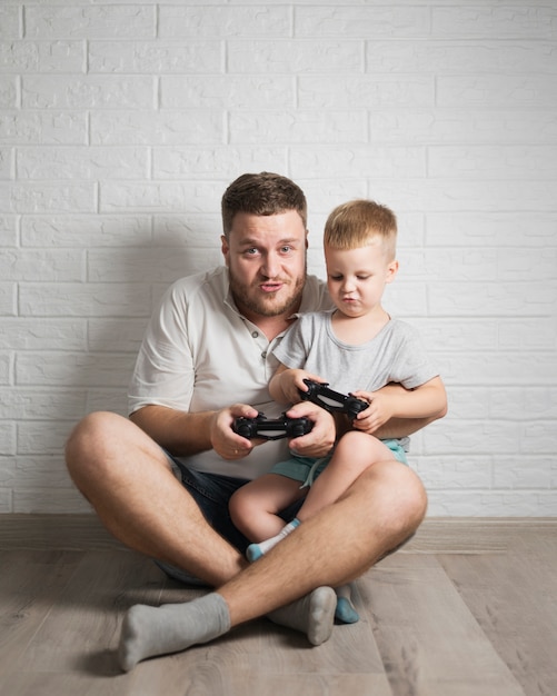 Free photo father and son at home playing together