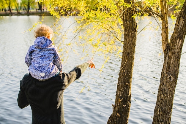 Foto gratuita padre e figlio guardando il lago