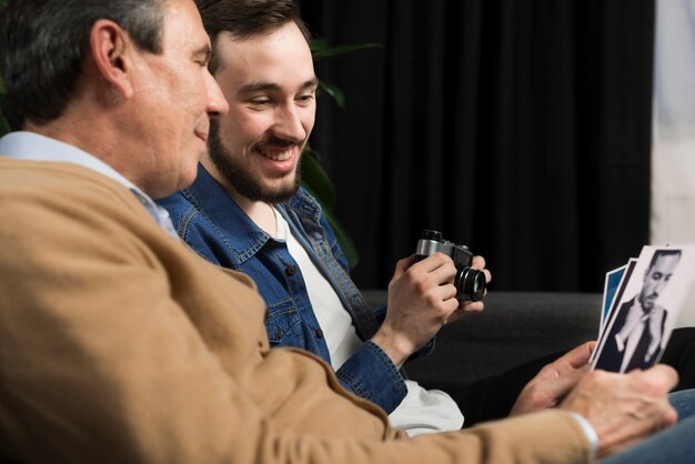 Father and son looking at pictures