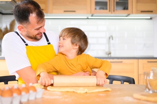 Father and son making a dough with the paddle