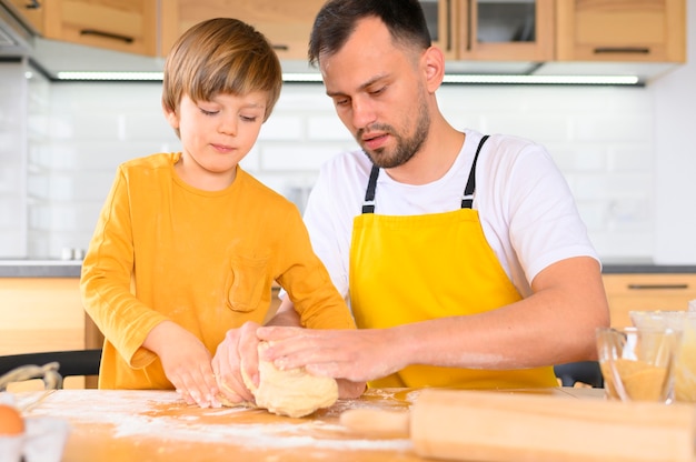 Father and son making dough