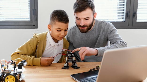 Father and son making robot