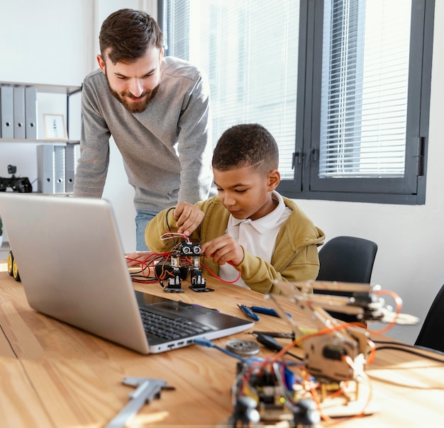 Father and son making robot