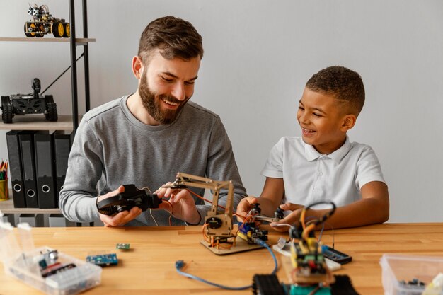 Father and son making robot