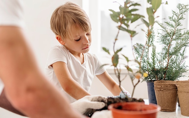 father and son planting plants together at home